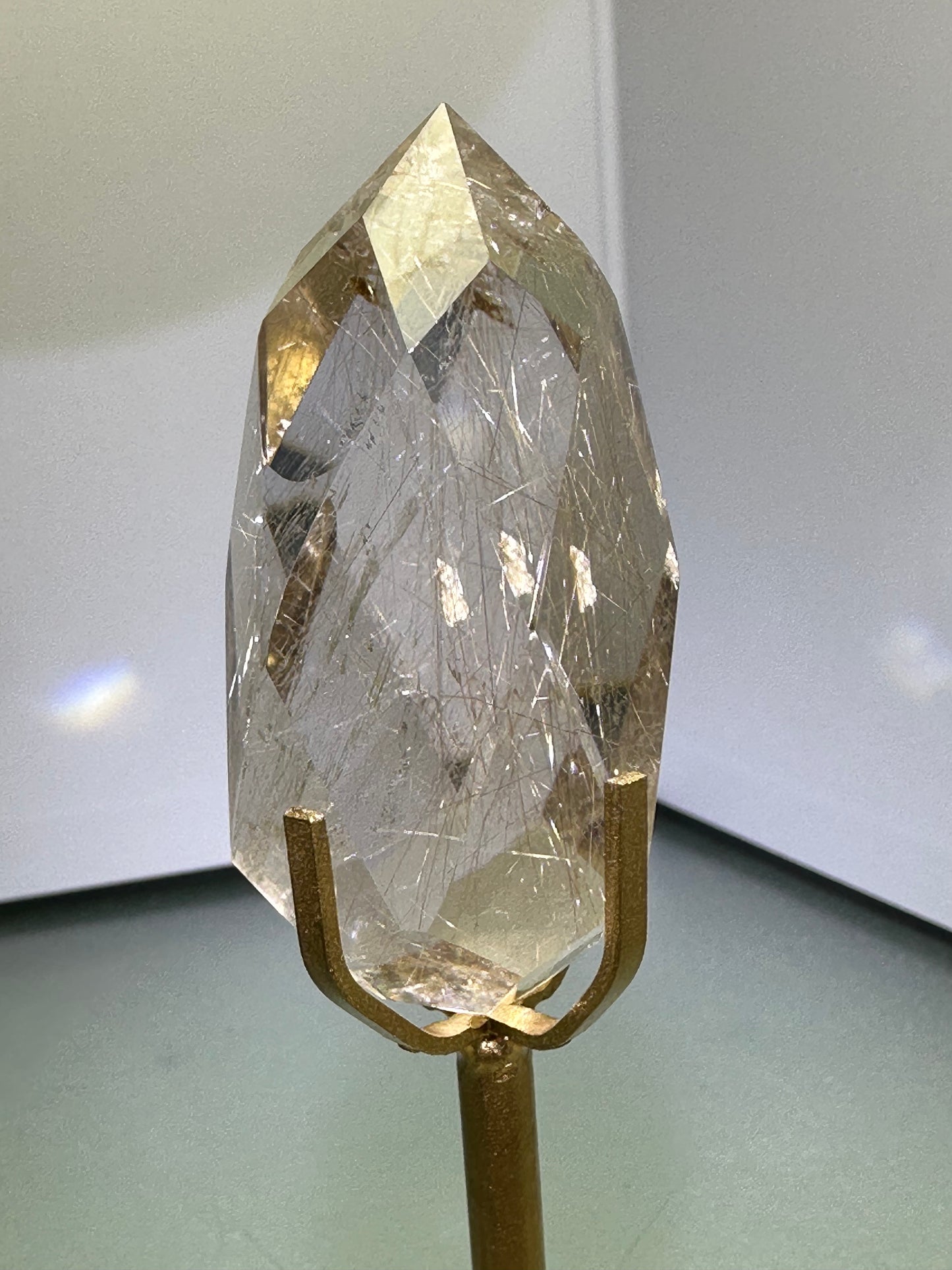 Faceted Rutile Smokey Quartz on stand